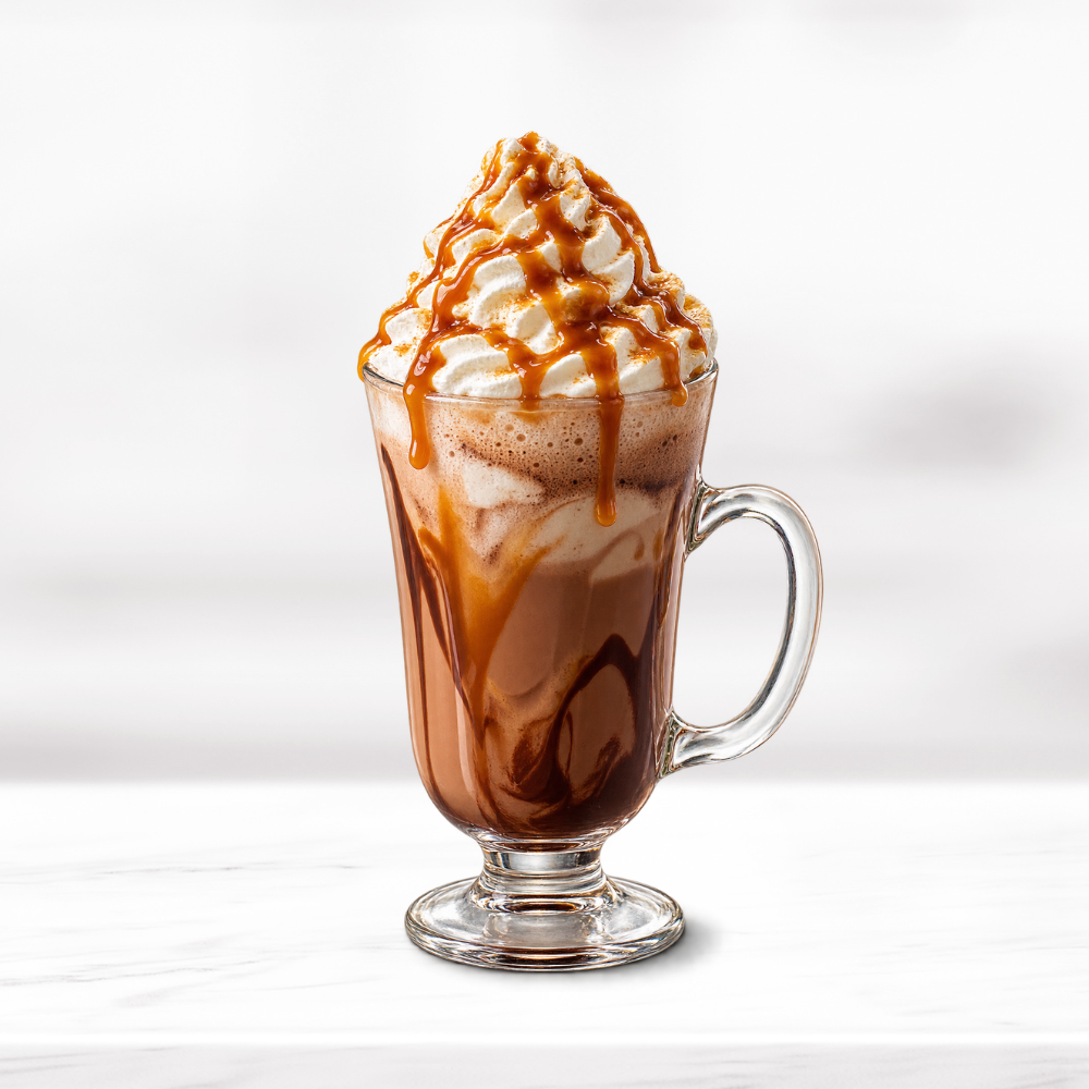 Salted caramel mochaccino topped with whipped cream and caramel drizzle in a glass mug